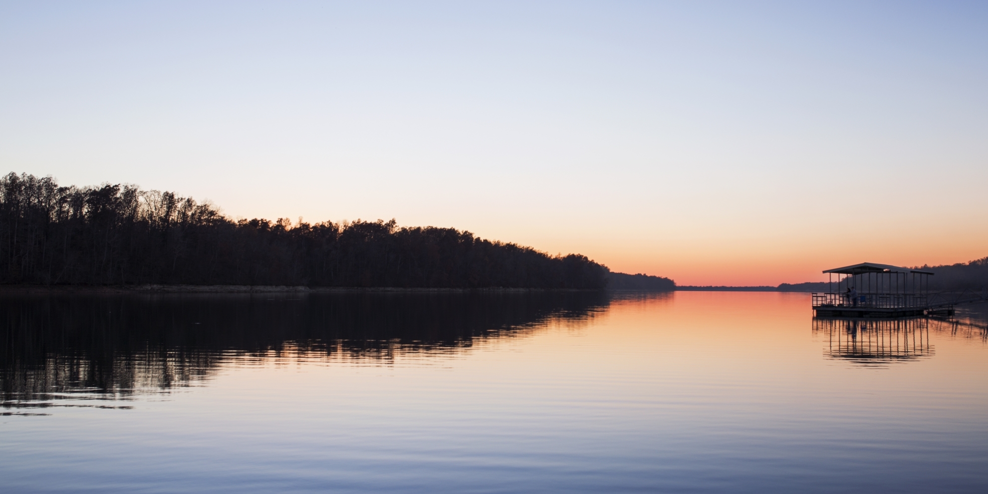 392415/Scenic view of lake against clear sky at sunset in Springfield Missouri